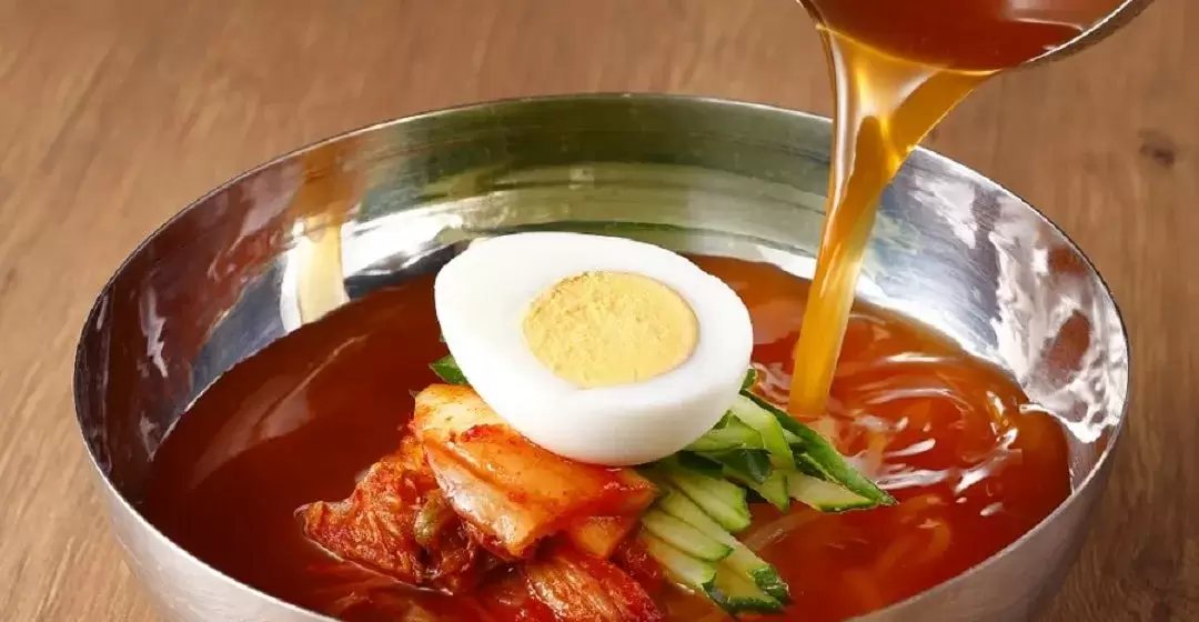 冷麺にスープを注ぐ様子